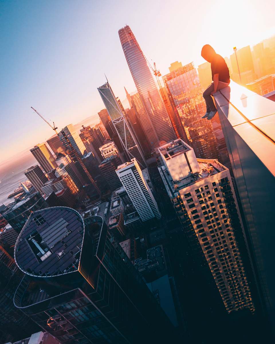 architecture person sitting on top of building during daytime urban
